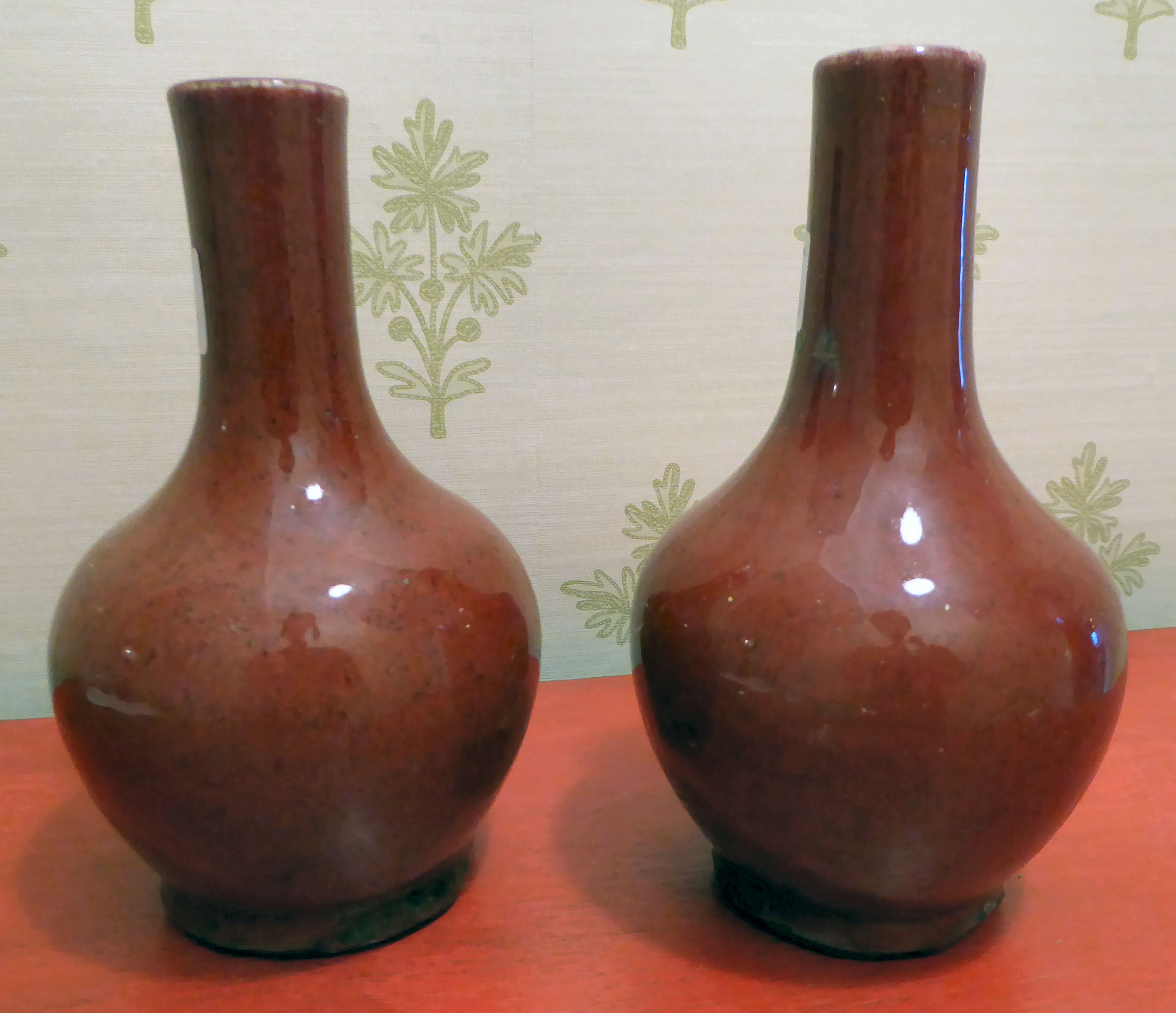 A pair of 20thC Chinese sang de boeuf porcelain vases of bulbous form with narrow necks 11''h - Image 2 of 4