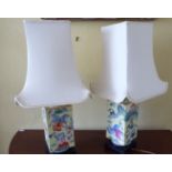 A pair of modern Chinese yellow glazed porcelain table lamps, decorated with fish and flora,