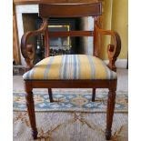An early 20thC Regency design mahogany framed elbow chair with a stripe upholstered seat,