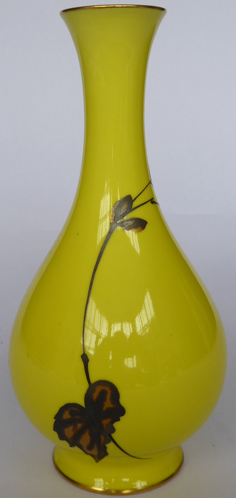 A 20thC Continental porcelain vase with a slender, waisted neck, decorated in gilt with foliage,