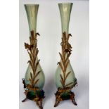 A pair of early 20thC vaseline coloured glass vases of slender, bulbous form with moulded ornament,