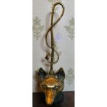 A late Victorian cast brass door porter,