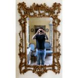 A mid 20thC Chippendale design gilt gesso framed mirror with ornately pierced ornament 55'' x 32''