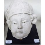 A composition stone cherubic head 10''h on a separate square black plinth T0S8