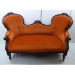 A late Victorian moulded and carved walnut showwood finished double spoonback settee,