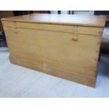 A 20thC teak chest with straight sides and a hinged lid,