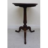 A George III stained oak tip-top pedestal table, raised on a ring turned,