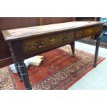 An Edwardian mahogany two drawer writing table, raised on ring turned,