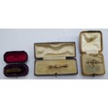 Three items of personal ornament: to include a gold coloured metal 'Baby' pin boxed OS10