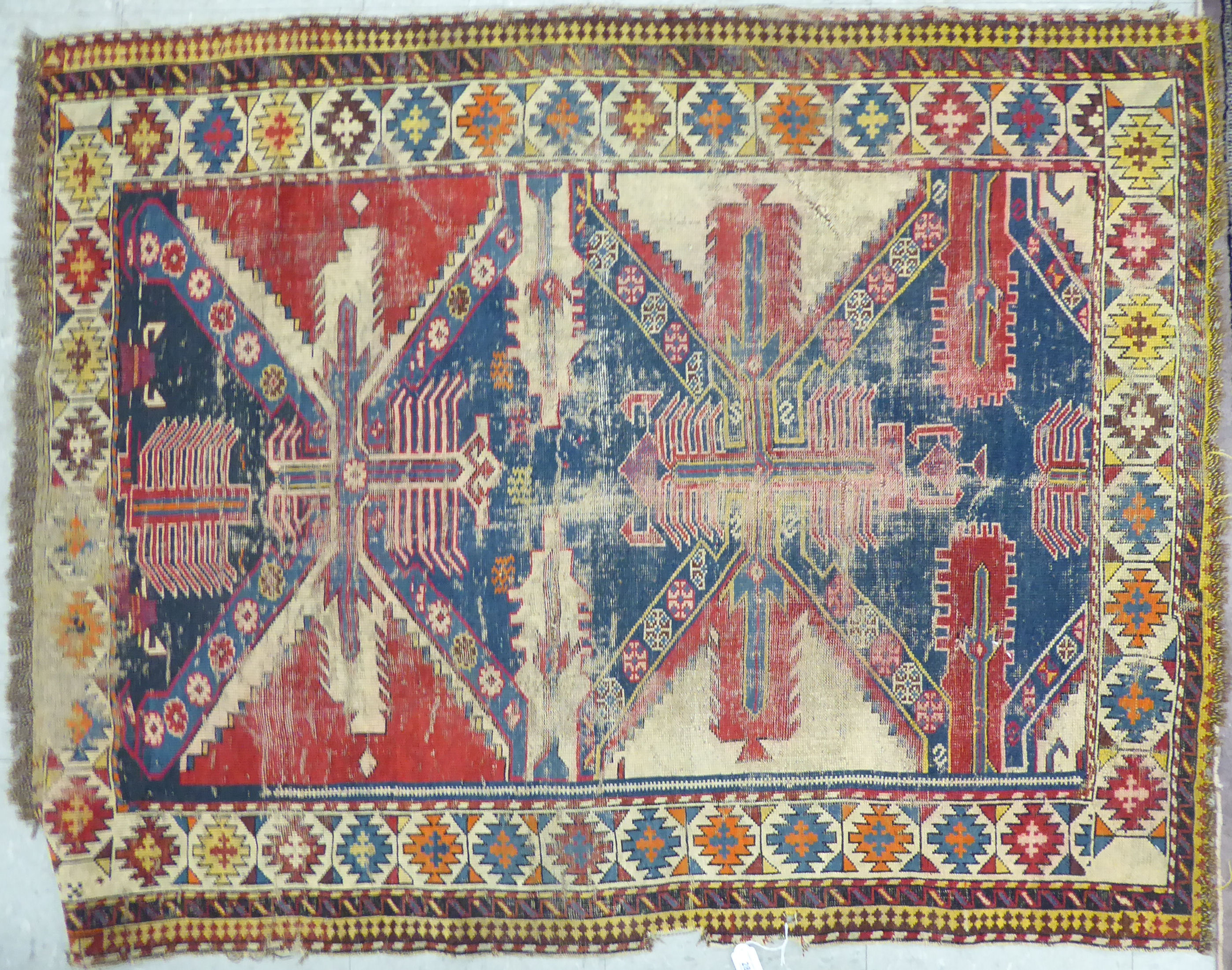 A Shirvan rug, decorated with repeating stylised designs,