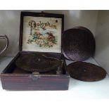 An early 20thC Polyphon, in a square, stained pine square case with six 6.