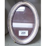 A silver mounted oval photograph frame,