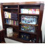 An early 20thC mahogany open front bookcase with two sections,