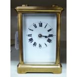 An early 20thC carriage timepiece with a lacquered brass case,