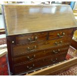 A George III mahogany bureau with a fall front, enclosing a fitted interior,