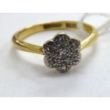 An 18ct gold diamond set daisy cluster ring 11