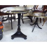 An early Victorian papier mache wine table, the oval top with a lobed edge,