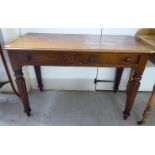 A late Victorian mahogany two drawer writing table,