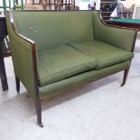 An Edwardian mahogany framed small salon settee, upholstered in green fabric, raised on square,
