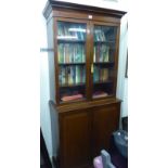 A late Victorian mahogany cabinet bookcase with a moulded cornice,