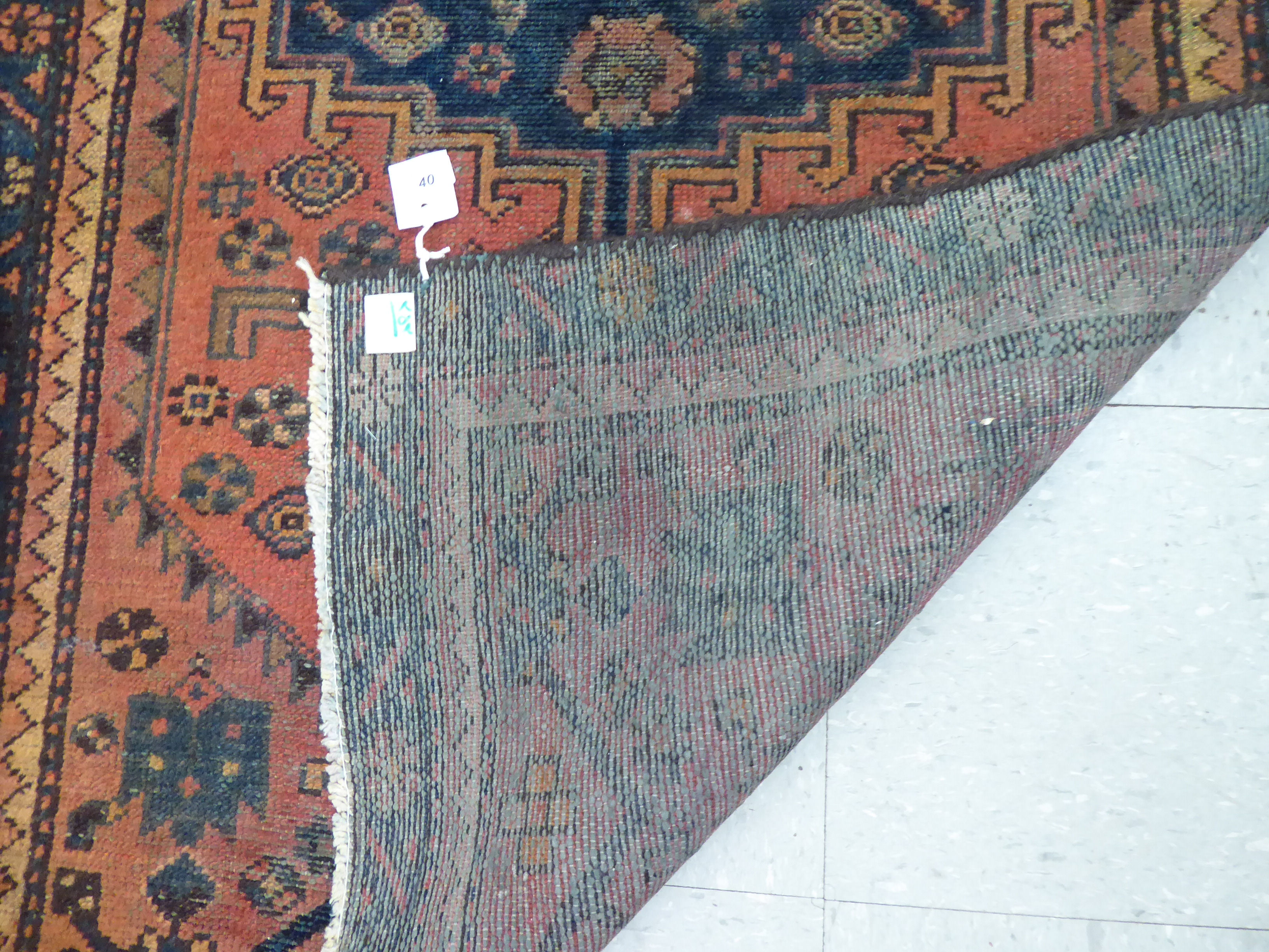 A Caucasian rug, decorated with a central medallion and stylised designs, - Image 3 of 3