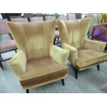 A pair of 1950/60s 'vintage' design low wingback chairs,