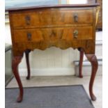 A 1930s walnut serpentine front two drawer bedside cabinet,