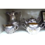 A late Victorian decoratively cast four piece silver plated tea set,