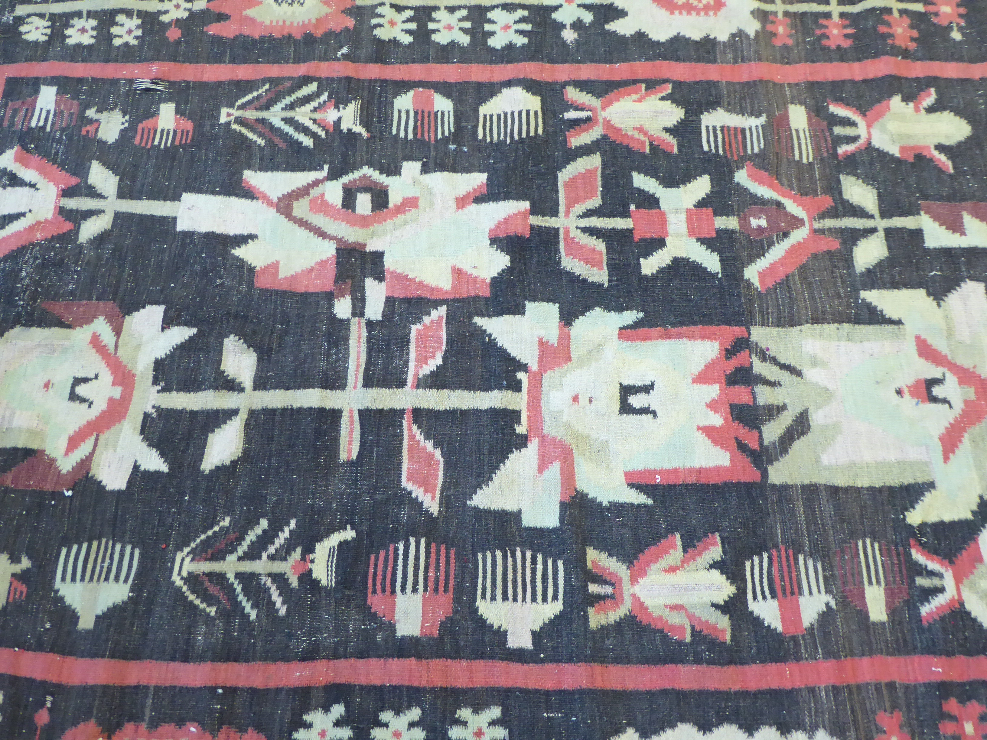 A Caucasian Kelim carpet, decorated with stylised abstract designs, - Image 2 of 3