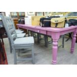 A 20thC pink painted pine refectory style kitchen table, raised on turned,
