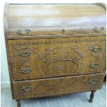 An early/mid 20thC relief carved, light oak bureau, the rising, quadrant,