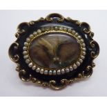 A mid 19thC yellow metal and enamel mourning brooch,