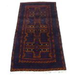 A Belouch rug, decorated with three central medallions, bordered by stylised designs,