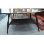 An Ercol stained elm and beech coffee table, the oval top raised on splayed,