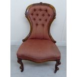 A late Victorian walnut framed nursing chair, the part buttoned,