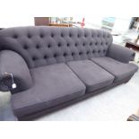 A mid 20thC three person settee, part button upholstered in dark brown fabric,
