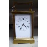 An early 20thC carriage timepiece with a lacquered brass case,