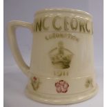 A Moorcroft green and pink on cream coloured glazed pottery mug of tapered form,