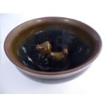 A Chinese stoneware bowl, set internally with a moulded animal,