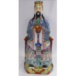 A 20thC Chinese porcelain figure, a seated official, wearing a colourful ceremonial costume 12.