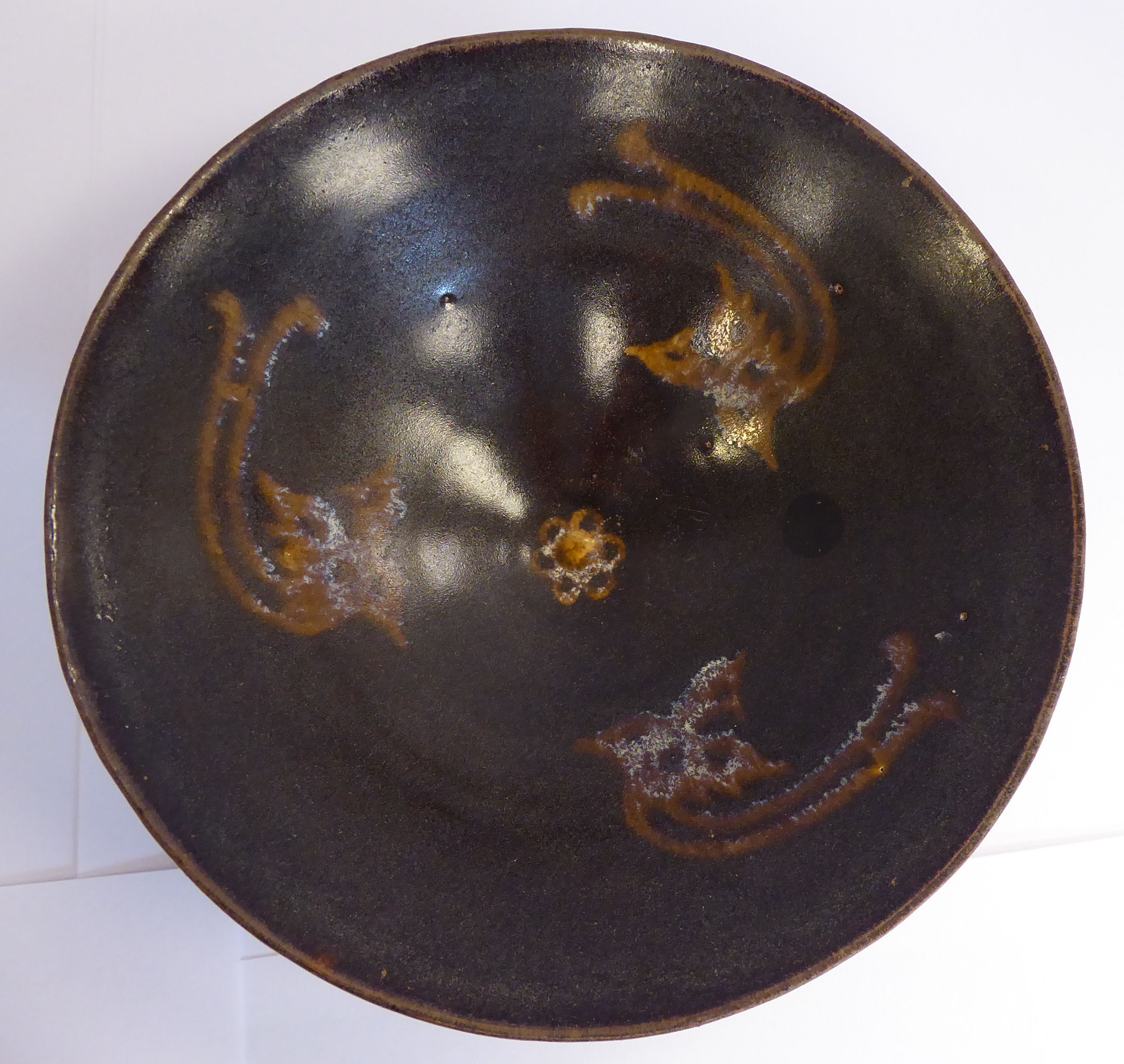 A Chinese pottery bowl, decorated with three dragon motifs,