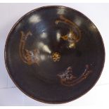 A Chinese pottery bowl, decorated with three dragon motifs,