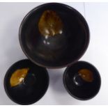 Three Chinese pottery bowls, each decorated with an autumnal leaf, on a brown glazed ground 2.