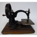 A Willcox & Gibbs Sewing Machine Co manual sewing machine with a circular frame,