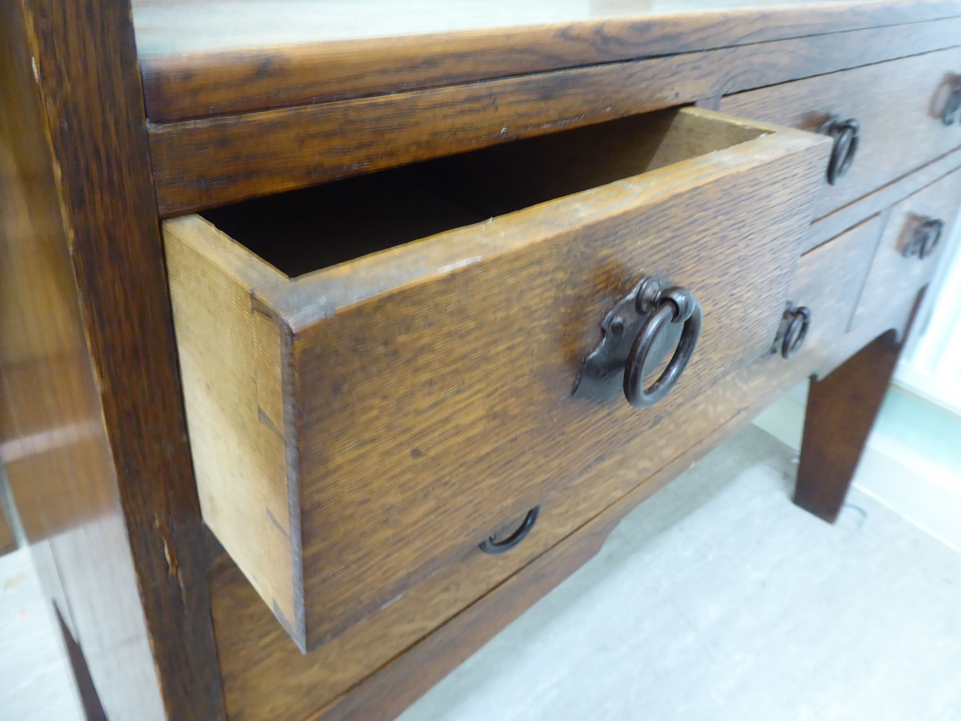 An early 20thC Arts & Crafts boarded oak dressing chest in the manner of Liberty, - Image 6 of 7