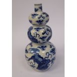 A late 19thC Chinese porcelain triple gourd design vase, decorated in blue and white with lion dogs,