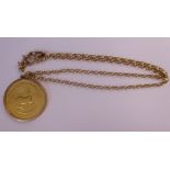A 1975 1oz Krugerrand, set in a 9ct gold pendant frame,
