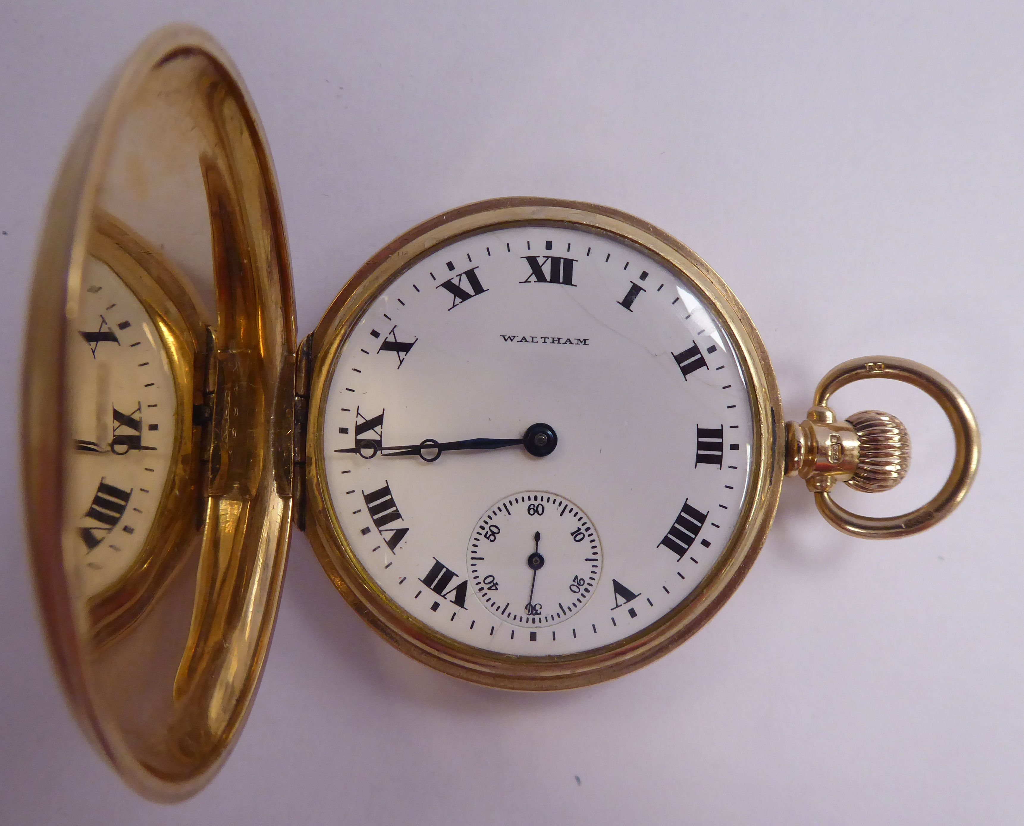 A Waltham 9ct gold cased full hunter pocket watch the keyless movement faced by a white enamel R