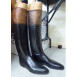 A pair of lady's black and brown leather riding boots,