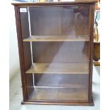 An early 20thC rustically constructed, honey coloured pine display cabinet with a glazed door,